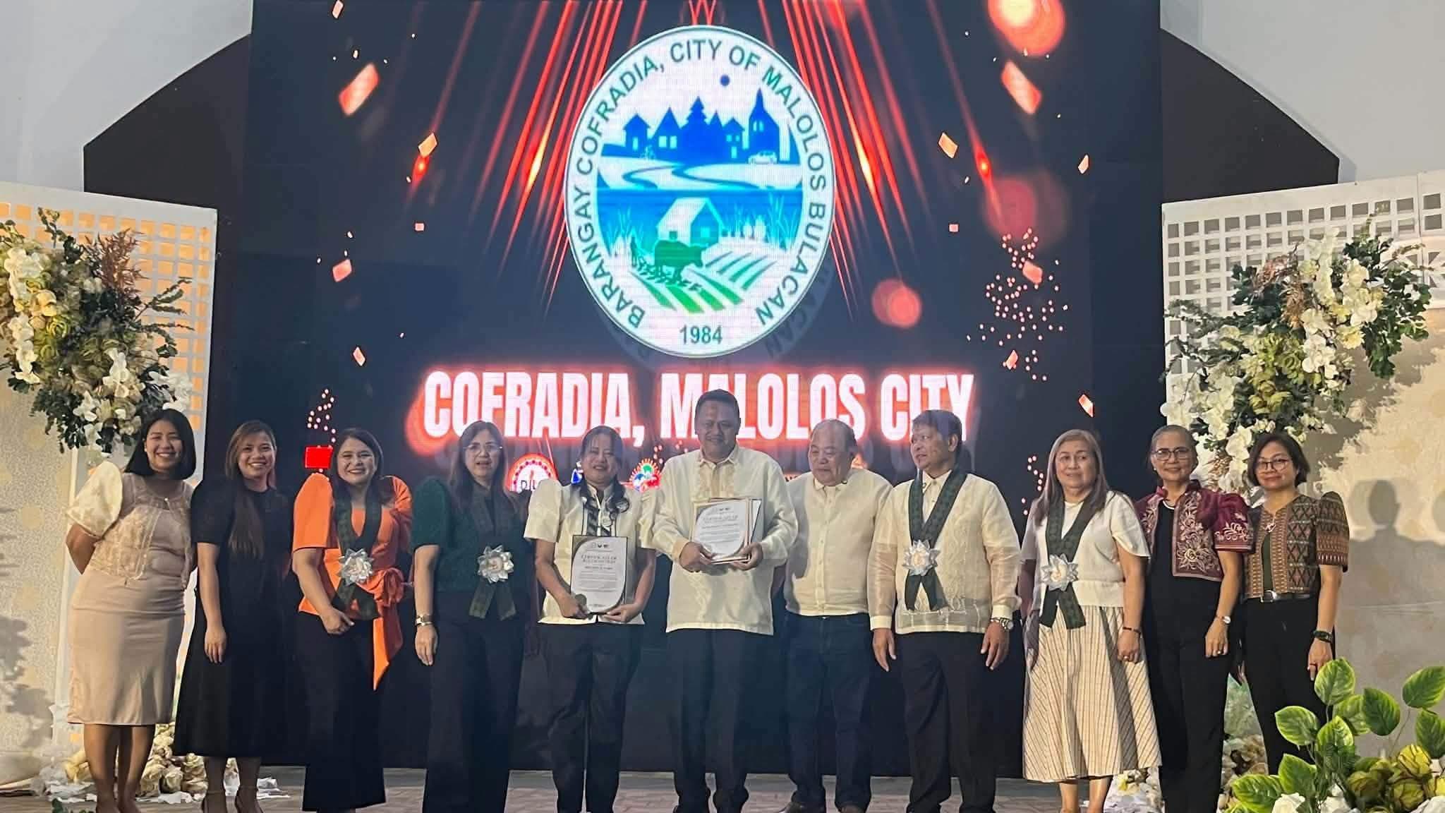 Barangay Cofradia receiving recognition as a Regional Passer of B.E.S.T. Barangay